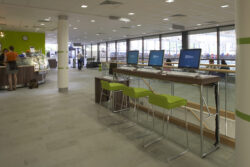 Computer cluster cafe area with monitors on display to highlight the risks of data breach or unauthorised access.